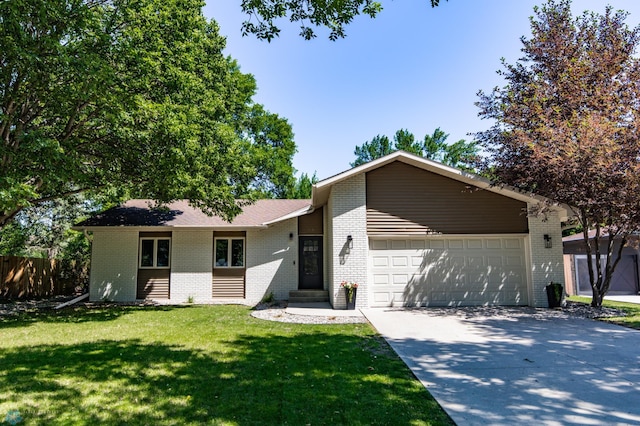 25 Birch Ln S, Fargo, ND 58103 - view of front of home with brick siding, a garage, and concrete driveway