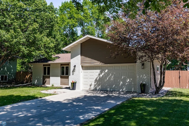 25 Birch Ln S, Fargo, ND 58103 - view of front facade with brick siding, driveway, and a garage