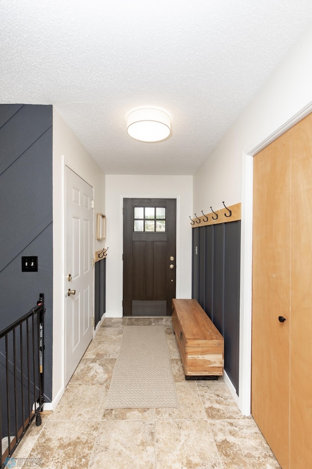 25 Birch Ln S, Fargo, ND 58103 - mudroom featuring a textured ceiling and baseboards