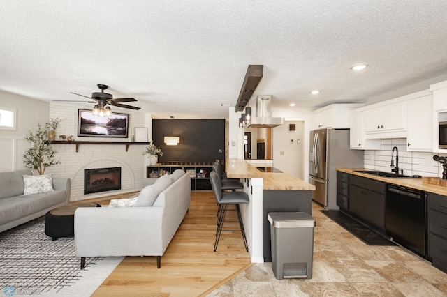 25 Birch Ln S, Fargo, ND 58103 - living area featuring a textured ceiling, a fireplace, a ceiling fan, and recessed lighting