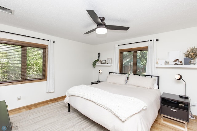 25 Birch Ln S, Fargo, ND 58103 - bedroom with a textured ceiling, wood finished floors, and a ceiling fan