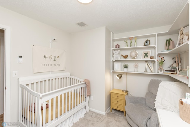 25 Birch Ln S, Fargo, ND 58103 - carpeted bedroom featuring a crib and a textured ceiling