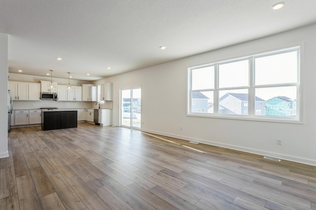 8362 Lander Ave NE, Otsego, MN 55330 - unfurnished living room featuring wood finished floors and recessed lighting