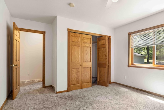 13384 Barnett Rd SW, Sylvan Twp, MN 56473 - unfurnished bedroom with light colored carpet, a closet, and a ceiling fan
