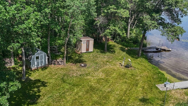 13384 Barnett Rd SW, Sylvan Twp, MN 56473 - view of green lawn featuring a storage unit and a water view