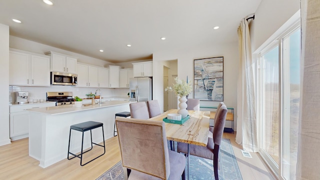 7593 Norway Ln, Lino Lakes, MN 55038 - kitchen with appliances with stainless steel finishes, light wood-style floors, white cabinets, and recessed lighting