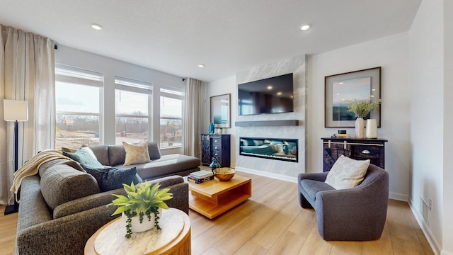 7593 Norway Ln, Lino Lakes, MN 55038 - living area featuring light wood-style floors, a fireplace, and recessed lighting