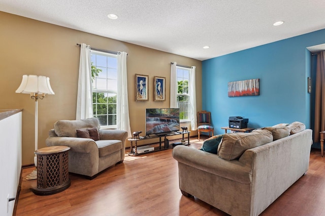 5214 Scott Ct, Robbinsdale, MN 55422 - living room featuring healthy amount of natural light, wood finished floors, a textured ceiling, and recessed lighting