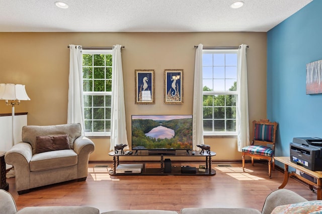 5214 Scott Ct, Robbinsdale, MN 55422 - living room with wood finished floors, recessed lighting, and a textured ceiling