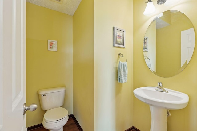 5214 Scott Ct, Robbinsdale, MN 55422 - bathroom with toilet and a textured ceiling