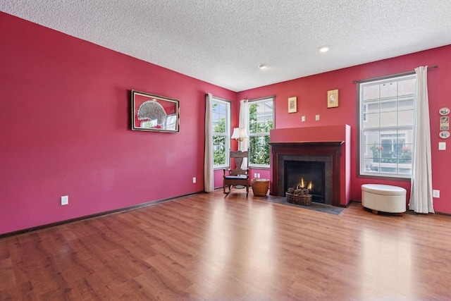 5214 Scott Ct, Robbinsdale, MN 55422 - living room with a textured ceiling, wood finished floors, a fireplace with flush hearth, and recessed lighting