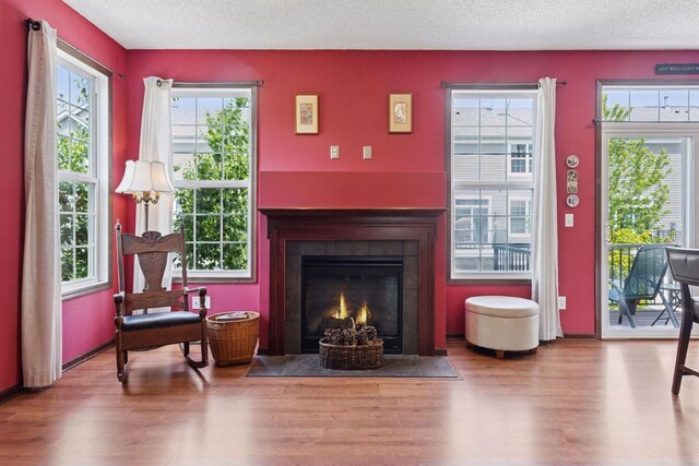 5214 Scott Ct, Robbinsdale, MN 55422 - sitting room with wood finished floors, a textured ceiling, and a fireplace with flush hearth