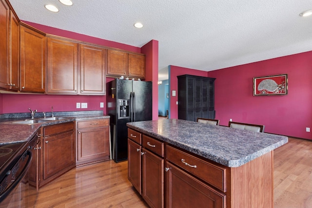 5214 Scott Ct, Robbinsdale, MN 55422 - kitchen featuring black appliances, light wood finished floors, dark countertops, a textured ceiling, and recessed lighting
