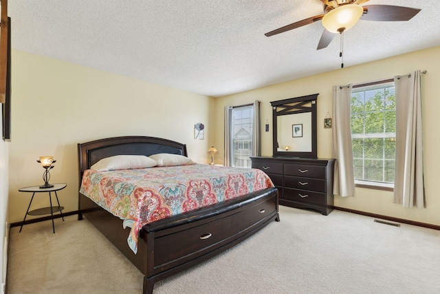 5214 Scott Ct, Robbinsdale, MN 55422 - bedroom with light colored carpet, a textured ceiling, and a ceiling fan