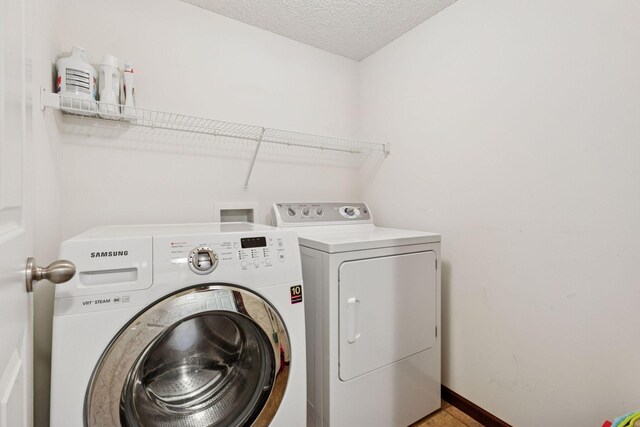 5214 Scott Ct, Robbinsdale, MN 55422 - washroom with washer and dryer and a textured ceiling