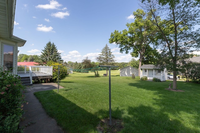 104 County Rd N, Le Roy, MN 55951 - view of grassy yard with a deck and an outbuilding