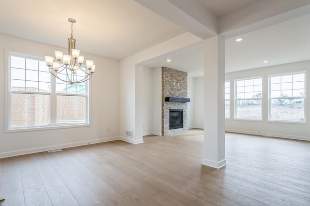 6722 Tamarack Ln, Corcoran, MN 55340 - unfurnished living room with a chandelier, wood finished floors, a fireplace, and recessed lighting