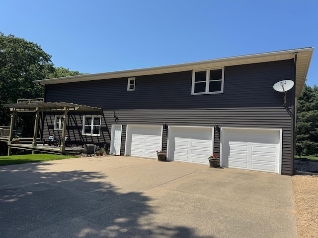 715 250th Ave, Fairmont, MN 56031 - view of front of house featuring a pergola, concrete driveway, and a garage