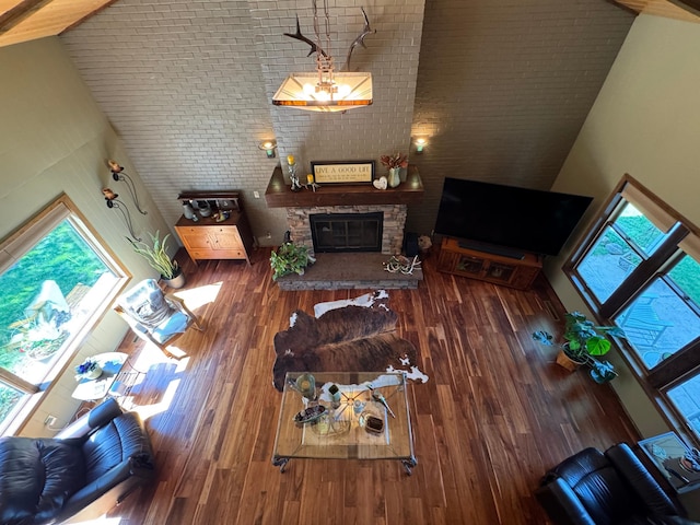 715 250th Ave, Fairmont, MN 56031 - living area featuring high vaulted ceiling, a fireplace, and wood finished floors