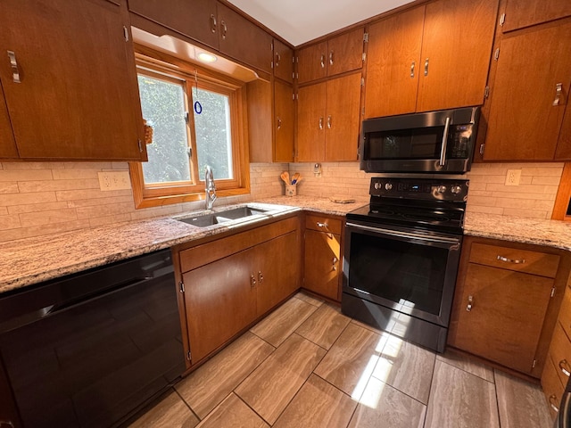715 250th Ave, Fairmont, MN 56031 - kitchen featuring black appliances, backsplash, and brown cabinetry