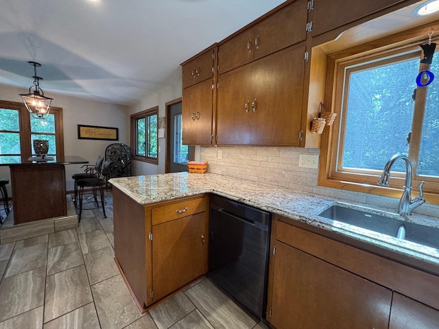 715 250th Ave, Fairmont, MN 56031 - kitchen featuring dishwasher, a peninsula, backsplash, pendant lighting, and light stone counters