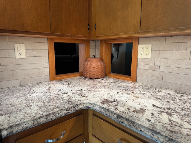715 250th Ave, Fairmont, MN 56031 - kitchen view of tasteful backsplash, light stone countertops, and brown cabinetry