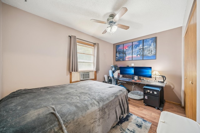 2227 3rd St SW, Rochester, MN 55902 - bedroom with wood finished floors, a textured ceiling, a ceiling fan, a desk, and cooling unit