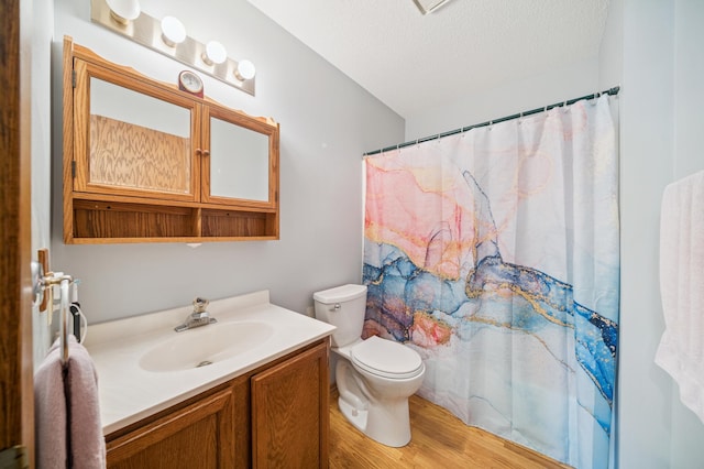2227 3rd St SW, Rochester, MN 55902 - bathroom featuring vanity, wood finished floors, a textured ceiling, and a shower with curtain