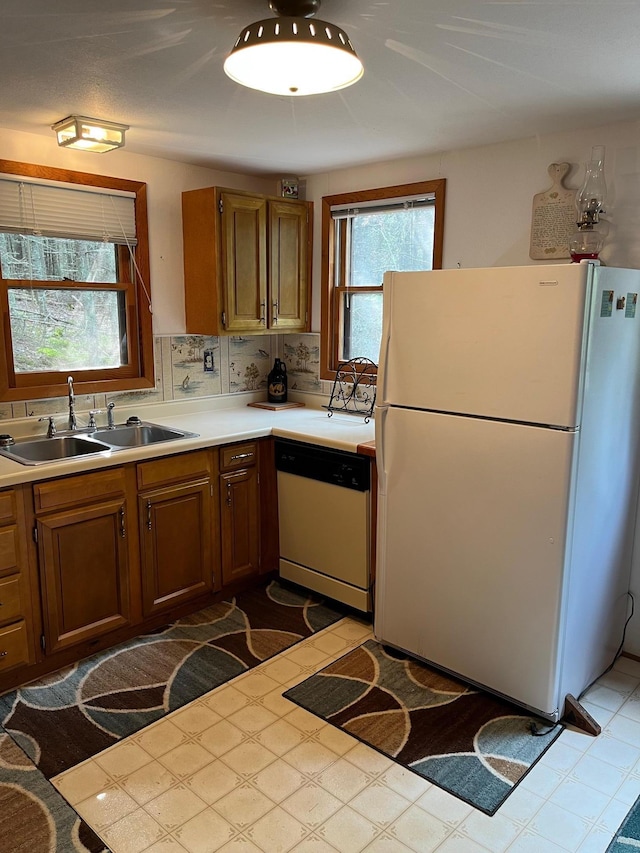 2485 Keyes Is, International Falls, MN 56649 - kitchen with white appliances, light countertops, tile patterned floors, and brown cabinets