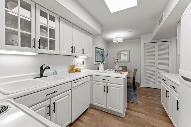 3412 Oak Ridge Rd Unit 208, Minnetonka, MN 55305 - kitchen with dishwasher, a peninsula, white cabinetry, light wood-style flooring, and glass insert cabinets