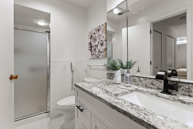 3412 Oak Ridge Rd Unit 208, Minnetonka, MN 55305 - bathroom with tile patterned flooring, vanity, a shower stall, tile walls, and a wainscoted wall