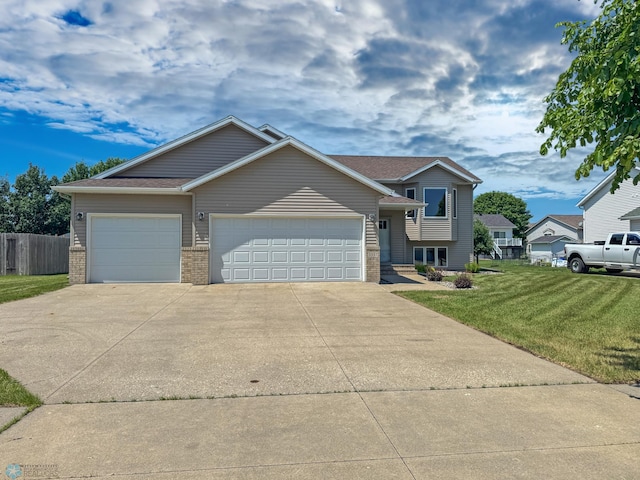 3337 Monroe St S, Fargo, ND 58104 - tri-level home with an attached garage, driveway, and brick siding