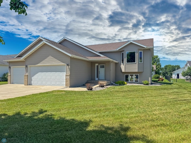 3337 Monroe St S, Fargo, ND 58104 - tri-level home featuring an attached garage, driveway, a front lawn, and a shingled roof