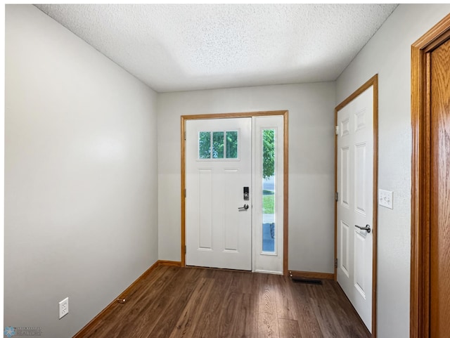 3337 Monroe St S, Fargo, ND 58104 - entrance foyer featuring dark wood-type flooring and a textured ceiling