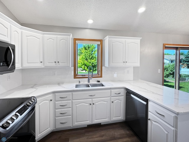 3337 Monroe St S, Fargo, ND 58104 - kitchen with dishwashing machine, electric range oven, a textured ceiling, a peninsula, and backsplash