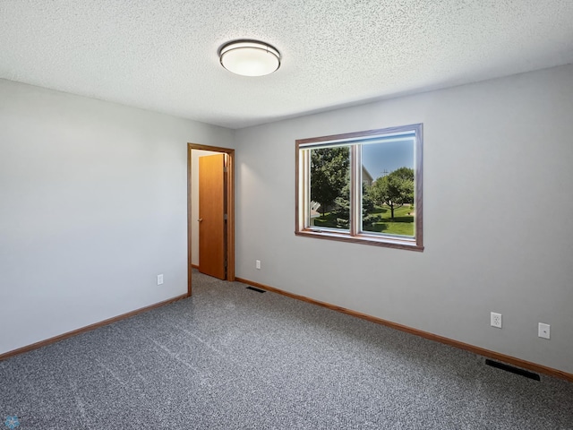 3337 Monroe St S, Fargo, ND 58104 - spare room featuring carpet flooring and a textured ceiling