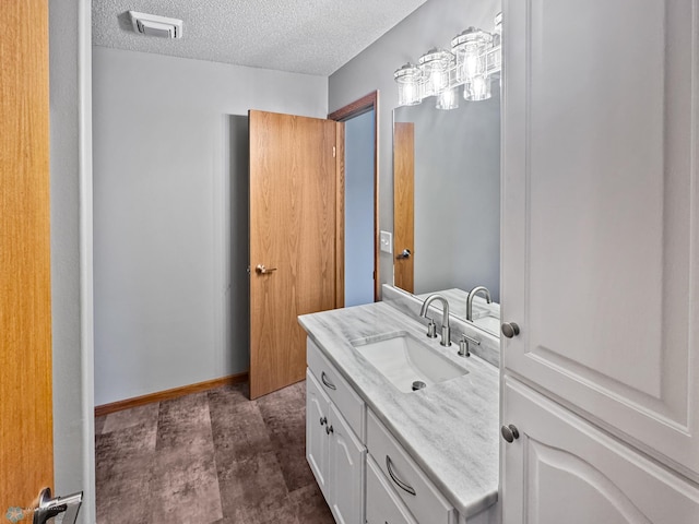 3337 Monroe St S, Fargo, ND 58104 - bathroom with vanity and a textured ceiling