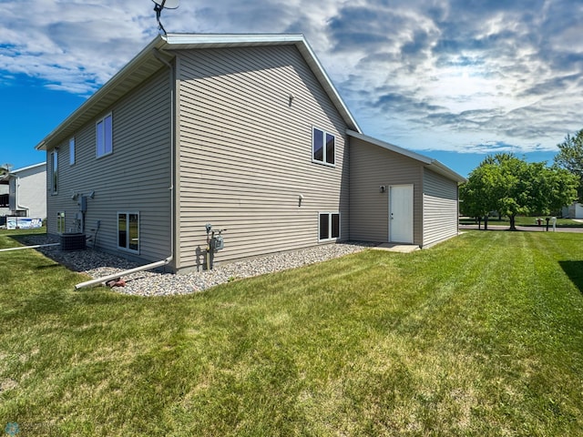 3337 Monroe St S, Fargo, ND 58104 - view of side of property with a lawn and a central AC unit