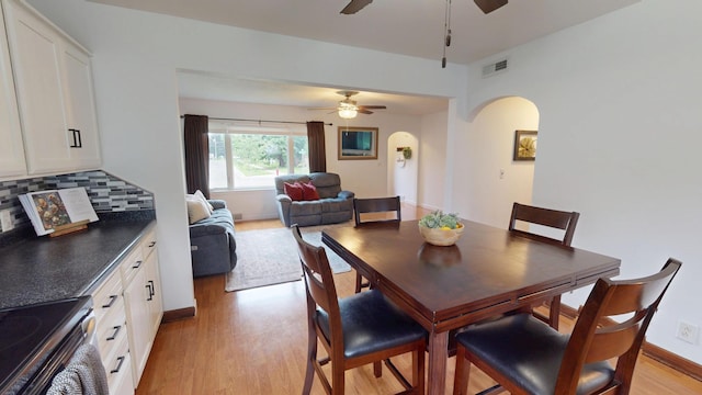 711 5th Ave SW, Austin, MN 55912 - dining area featuring ceiling fan, arched walkways, and light wood-style floors