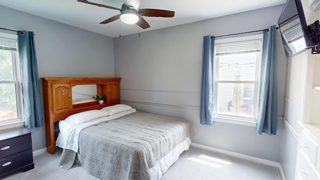 711 5th Ave SW, Austin, MN 55912 - bedroom with light colored carpet, multiple windows, and ceiling fan