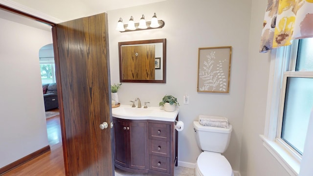 711 5th Ave SW, Austin, MN 55912 - half bath featuring vanity and wood finished floors