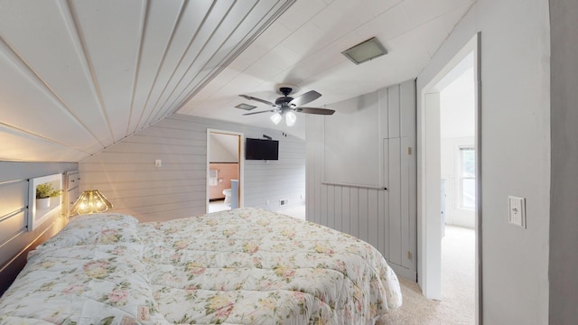 711 5th Ave SW, Austin, MN 55912 - bedroom with vaulted ceiling, carpet floors, wood walls, and ceiling fan