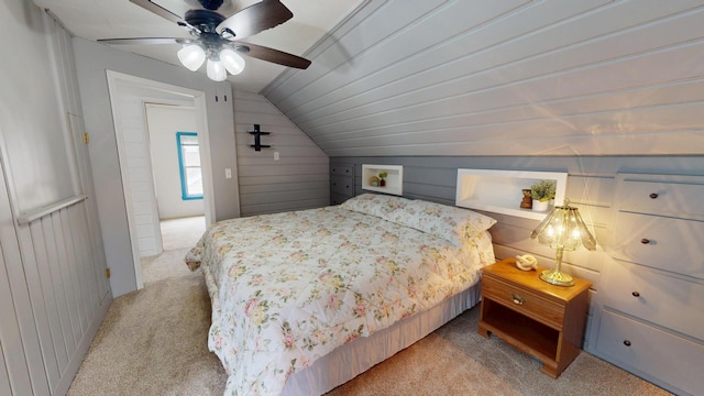 711 5th Ave SW, Austin, MN 55912 - bedroom featuring light carpet, lofted ceiling, wooden walls, and a ceiling fan