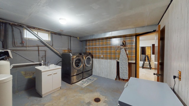 711 5th Ave SW, Austin, MN 55912 - below grade area with washer and clothes dryer, wood walls, and a water softener system