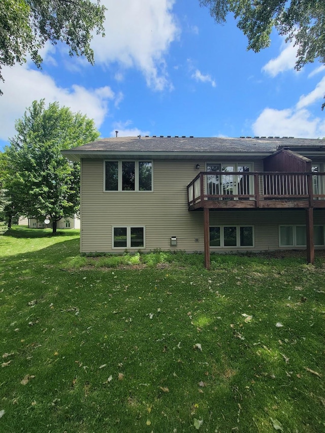 2729 Parkhaven Ct N, Brooklyn Park, MN 55444 - back of property featuring a lawn and a wooden deck