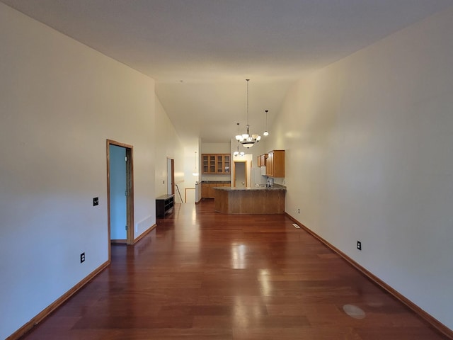 2729 Parkhaven Ct N, Brooklyn Park, MN 55444 - unfurnished living room featuring a chandelier, high vaulted ceiling, and dark wood-style flooring