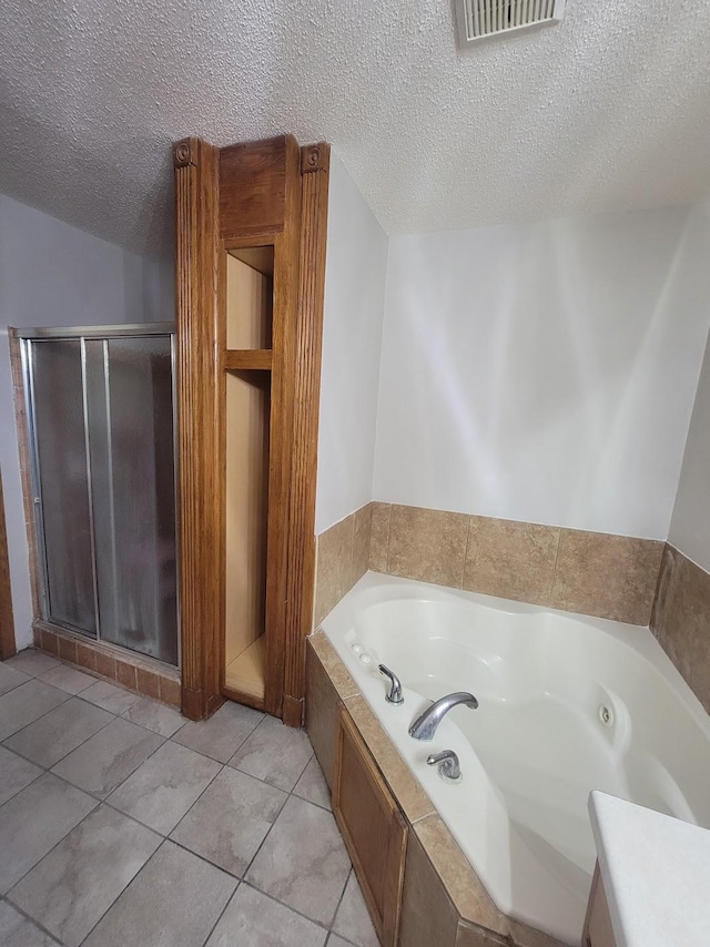 2729 Parkhaven Ct N, Brooklyn Park, MN 55444 - bathroom with a jetted tub, a textured ceiling, a shower stall, and tile patterned floors
