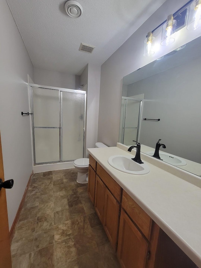 2729 Parkhaven Ct N, Brooklyn Park, MN 55444 - full bathroom featuring a shower stall, vanity, a textured ceiling, and stone finish flooring