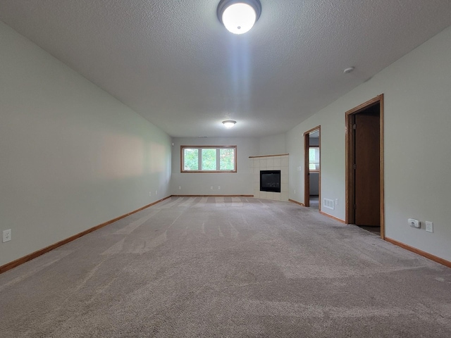 2729 Parkhaven Ct N, Brooklyn Park, MN 55444 - unfurnished living room with light carpet, a textured ceiling, and a tile fireplace
