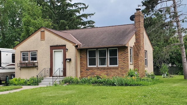2122 Lacrosse Ave, Saint Paul, MN 55119 - view of front of house with a chimney, a front yard, roof with shingles, brick siding, and stucco siding